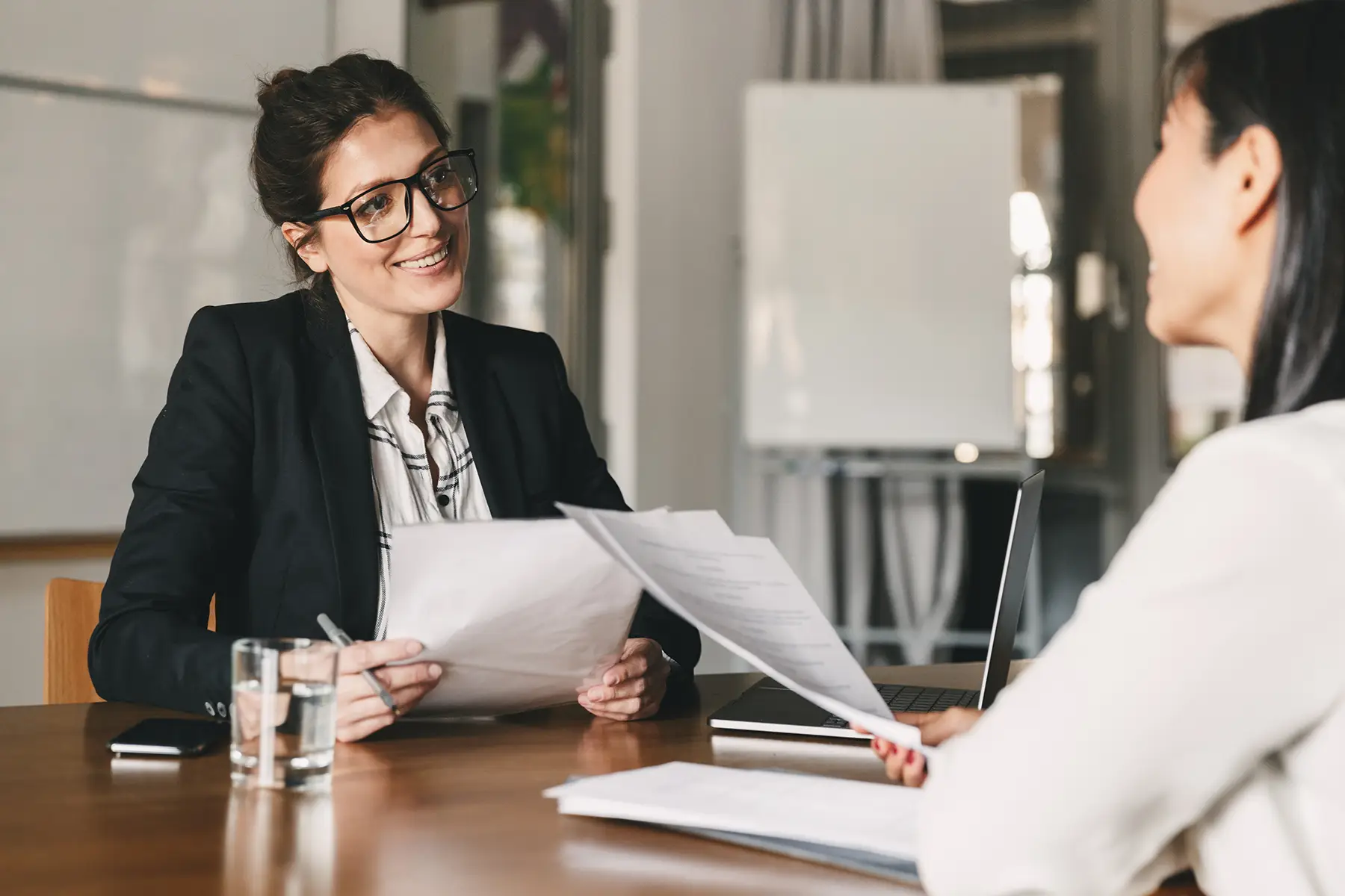 Portrait of smiling businesswoman holding resume