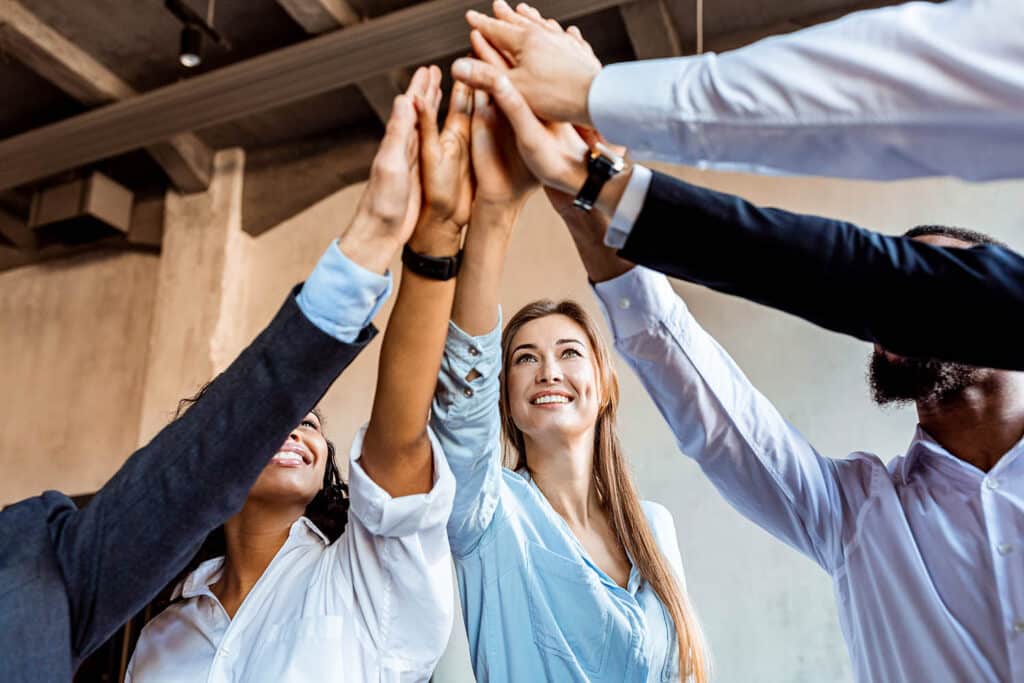 Joyful Team Of Coworkers Giving High-Five Celebrating