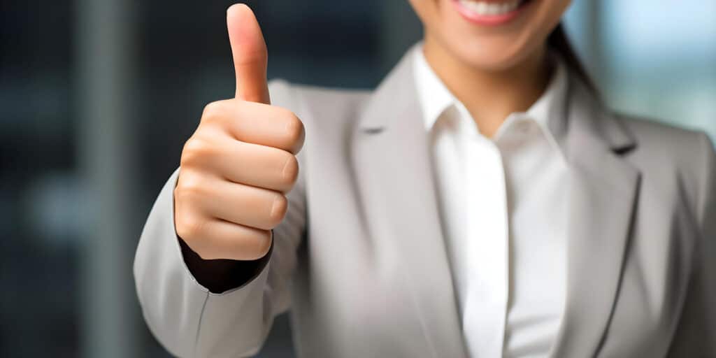 Woman giving thumbs up for positive feedback on product or service.